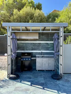 a kitchen under a pergola with a stove at Casa Loma 2 in Rhodes Town