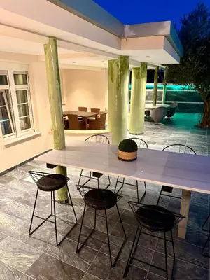 a large table with chairs in a patio at Casa Loma 2 in Rhodes Town