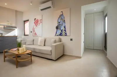 a living room with a couch and a table at Elysian Suite in Rhodes Town