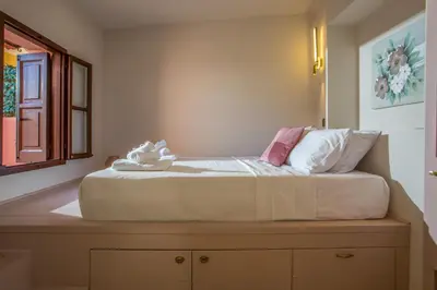 a bed sitting on top of a dresser in a bedroom at Elysian Suite in Rhodes Town