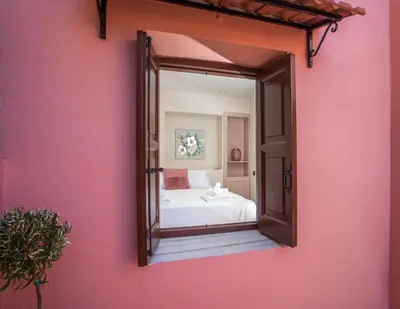 a mirror on the side of a pink wall at Elysian Suite in Rhodes Town