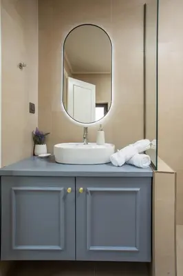 a bathroom with a sink and a mirror at Elysian Suite in Rhodes Town