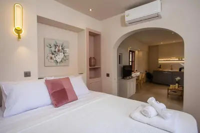 a bedroom with a white bed with towels on it at Elysian Suite in Rhodes Town