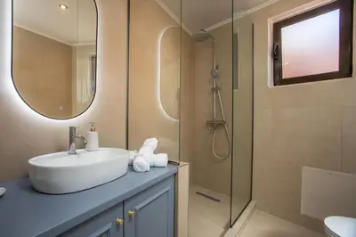 a bathroom with a sink and a shower at Elysian Suite in Rhodes Town