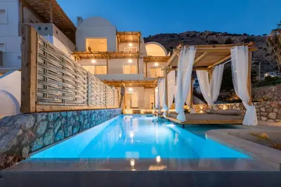 a swimming pool in front of a house at KIVOTOS BLACK Horse in Pefki Rhodes