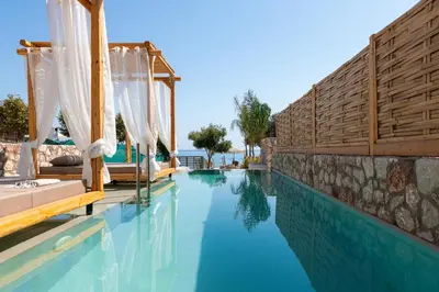 a pool at a resort with blue water at KIVOTOS BLACK Horse in Pefki Rhodes