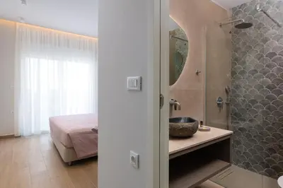 a bathroom with a sink and a shower in a room at KIVOTOS BLACK Horse in Pefki Rhodes