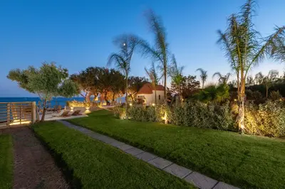 a garden with a pathway and a house with lights at KIVOTOS BLACK Horse in Pefki Rhodes