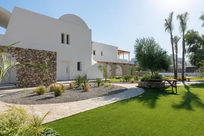 a house with a yard with grass and trees at KIVOTOS BLACK Horse in Pefki Rhodes