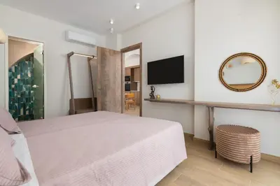 a hotel room with a bed and a mirror at KIVOTOS BLACK Horse in Pefki Rhodes