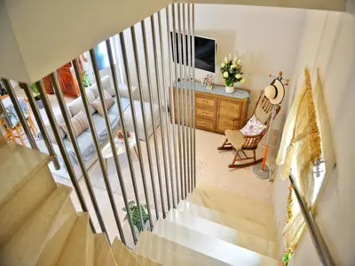 a staircase in a room with a bed and a television at Elegant Villa with Pool & Garden in Eleousis in Kalithies