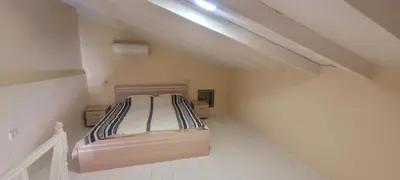a bedroom with a bed in an attic at Villa Salachouri in Symi