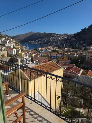 a view of a city from the balcony of a house at Villa Salachouri in Symi