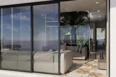 a living room with glass walls and a couch at Monte Smith Aether & Aura Villas in Ixia