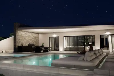 a villa with a swimming pool at night at Monte Smith Aether & Aura Villas in Ixia