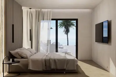 a bedroom with a bed and a view of the ocean at Monte Smith Aether & Aura Villas in Ixia