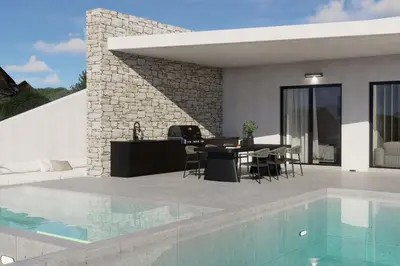 a patio with a table and chairs next to a swimming pool at Monte Smith Aether & Aura Villas in Ixia