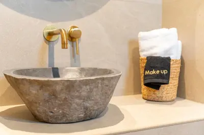 a bathroom sink with a faucet on a counter at Naiades Guest House in Sálakos