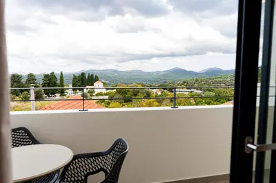 a balcony with a view of the mountains at Naiades Guest House in Sálakos
