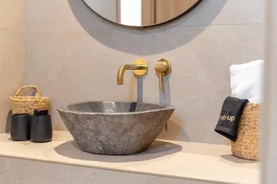 a bathroom with a bowl sink and a faucet at Naiades Guest House in Sálakos