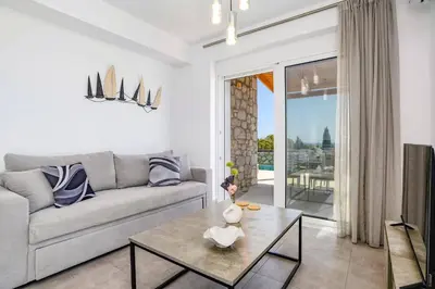 a living room with a couch and a table at Villa Amethyst Gem by Villa Plus in Gennadi