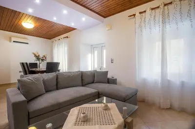 a living room with a couch and a table at La Casa Di Kika in Malona Village