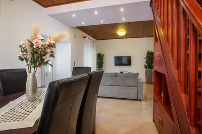 a dining room with a table and a couch at La Casa Di Kika in Malona Village