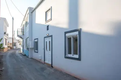 a white building with a window on the side of a street at La Casa Di Kika in Malona Village