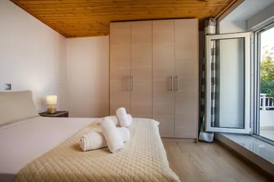 a bedroom with a large bed with towels on it at La Casa Di Kika in Malona Village