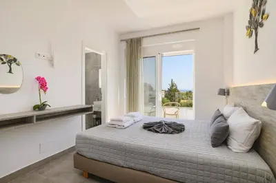 a bedroom with a large bed with a window at Villa Ruby Gem by Villa Plus in Gennadi