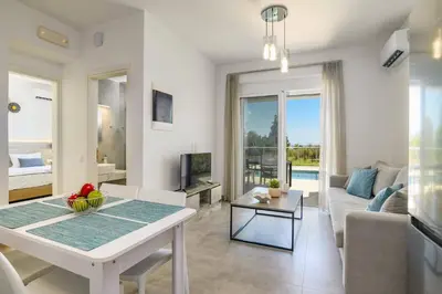 a living room with a table and a couch at Villa Ruby Gem by Villa Plus in Gennadi