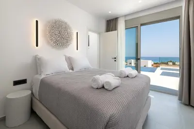 a bedroom with a bed with towels on it at Lindian Poem Villas in Líndos