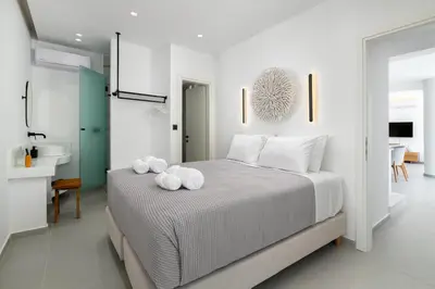a bedroom with a bed with two towels on it at Lindian Poem Villas in Líndos