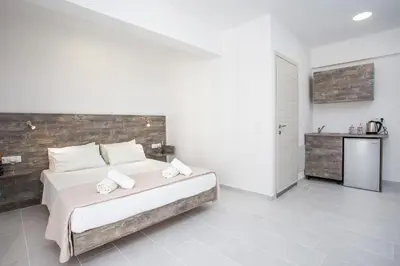 a bedroom with a large white bed with white pillows at Anika Studios Faliraki in Faliraki