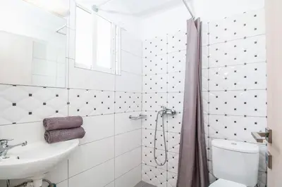 a bathroom with a shower and a toilet and a sink at Anika Studios Faliraki in Faliraki