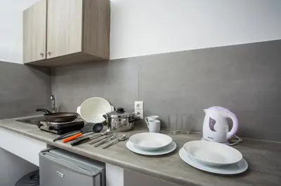a kitchen with a counter top with plates and a mixer at Anika Studios Faliraki in Faliraki