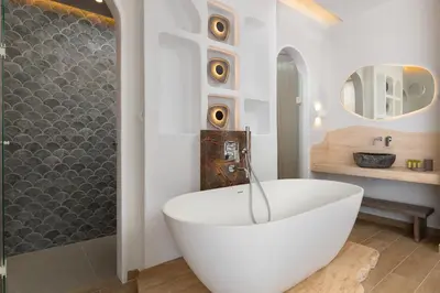a bathroom with a white tub and a sink at Kivotos Blue villa in Lardos