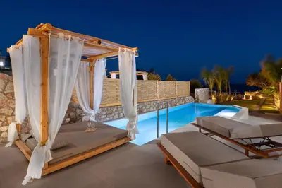 a patio with a gazebo and a swimming pool at Kivotos Blue villa in Lardos
