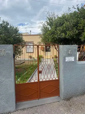 a gate to a garden in front of a house at Traditional Villa Stella in Archangelos