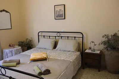 a bedroom with a bed with towels on it at Traditional Villa Stella in Archangelos