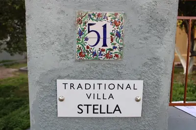 a sign that says traditional villa stella on a wall at Traditional Villa Stella in Archangelos