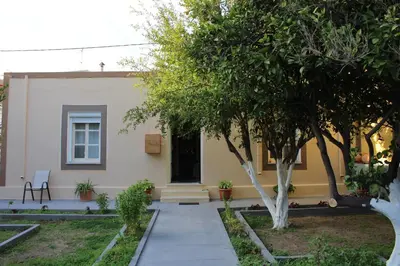 a house with a pathway leading to the front door at Traditional Villa Stella in Archangelos