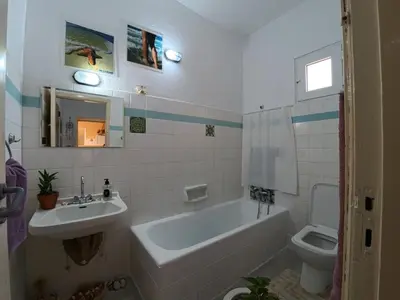 a bathroom with a tub and a sink and a toilet at Traditional Villa Stella in Archangelos