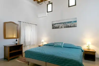 a bedroom with a blue bed and a mirror at Evdokia Old Town Hotel in Rhodes Town