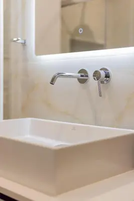 a bathroom sink with a faucet and a mirror at Marizaf house in Émbonas