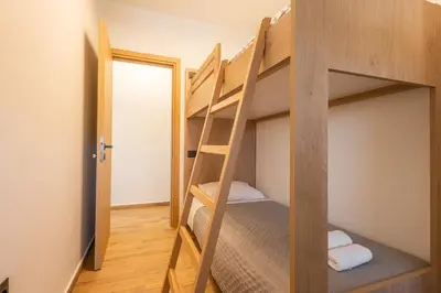 a room with two bunk beds with a doorway at Marizaf house in Émbonas