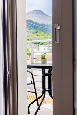 a table with a potted plant on a balcony at Marizaf house in Émbonas