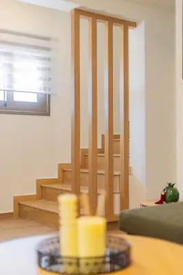 a living room with a staircase and a table at Marizaf house in Émbonas