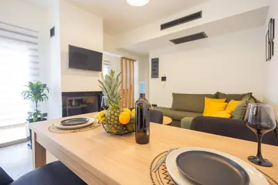 a living room with a table with a bottle of wine at Marizaf house in Émbonas