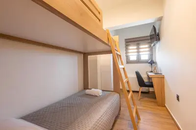 a bedroom with a bunk bed and a ladder at Marizaf house in Émbonas